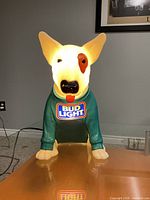 Front view of illuminated Spuds Mackenzie Bud Light bar lamp