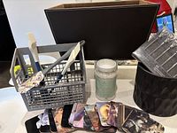 Group shot showing all items: coasters, utensil basket with utensils, PartyLite sand jar, black planter, packaged Harman skewers, faux leather box