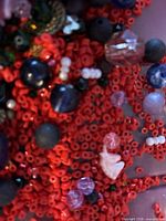 Close-up of small red seed beads with mixed larger beads