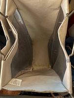 Top interior view showing three canvas compartments and mesh side panels