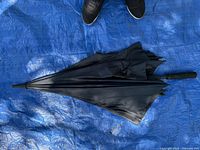 Umbrella closed showing black canopy exterior and handle