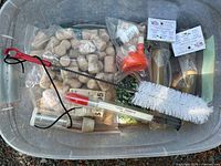 Winemaking accessories in tote: corks, corker, hydrometer, brush, tubing