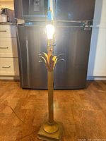 Whole lamp illuminated showing palm fronds and base