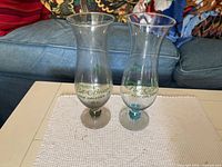 Pair of Pat O'Brien's hurricane glasses showing logo and tint