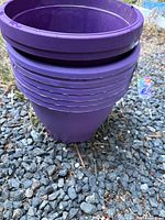 Stack of seven purple planters