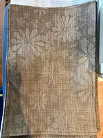Stack of brown tan floral woven vinyl placemats