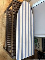 Top view of ironing board with blue and white striped cover