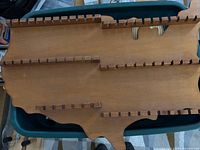 Full view of United States shaped wooden spoon rack showing overall design and notched rails