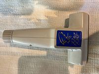 Top view showing gray plastic body and blue Vacuflo label