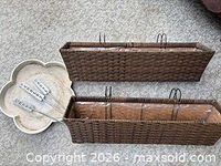 Two wicker planters with liners and set of plant markers displayed