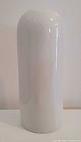 front view of white cylindrical porcelain vase