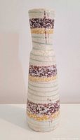 Full front view of tall striped West German vase