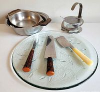 group shot of entire lot showing pans, platter, condiment holder, utensils
