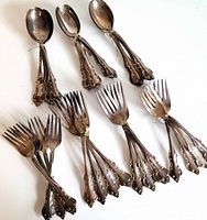 Overhead view of bundled forks and spoons showing quantity and variety