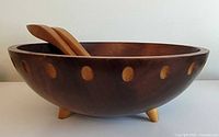 Side view of bowl on three legs with utensils inside, showing dot inlay