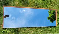 Full view of mirror front reflecting sky