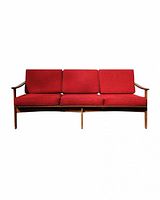 Front view of teak three-seat sofa with red cushions