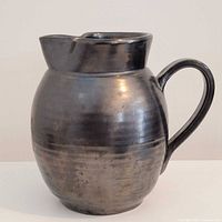 Front view of Prinknash pottery vase showing metallic glaze and handle