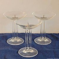 Three clear glass double stem candle holders front view