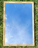 front view of mirror showing bamboo-style frame and reflective glass