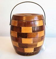 Front view of wood mosaic biscuit barrel with lid and handle