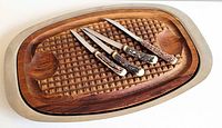 Board with knives atop showing overall set