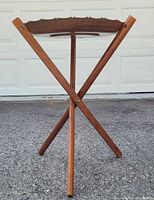 side view showing folded wooden tripod base with tray in place