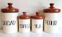 Full set of four canisters showing size differences and labels