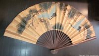 Full view of opened wall fan showing artwork and overall size