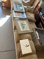 All four artworks displayed on sofa