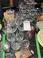 overview of mixed stemware, cardboard packed glasses, faux grapes
