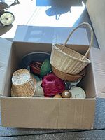 Overview of box showing baskets, silicone mold, metal bowl, wooden bowls, containers