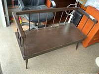 front angled view of bench showing spindle arms, legs, and seat surface