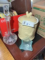 Group shot showing decanter, biscuit jar, and teal votive holder