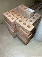 Stacked perforated clay bricks on basement floor
