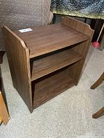 Front angled view of cabinet showing overall form and shelves