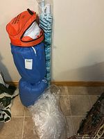 Group view of sleeping bags, bug net, umbrella, sleep sacs