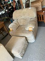 Front view of beige microsuede armchair with matching ottoman