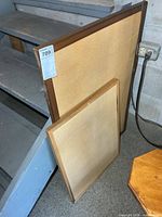 Both framed cork boards leaning against stair structure