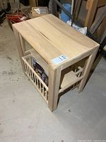 Overall view of unfinished solid wood end table with magazine storage