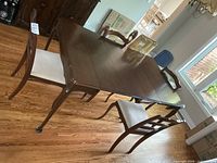 Dining table with two chairs visible