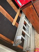 Full view of ladder stored against wall