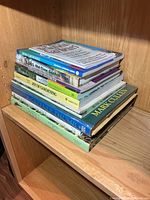 Stack of nine gardening books on shelf