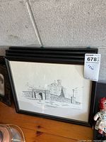 Stack of framed Gilder sketches showing front print