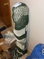 Hammock rolled up and tied, showing knit pattern and colors