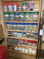 Full shelving unit showing jars of hardware