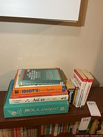 Overall view of stacked and standing Spanish learning books on shelf