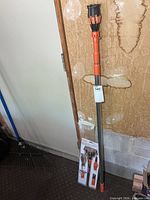 Full view of telescopic pole with packaged kit at base