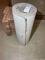 Full view of rolled grey carpet runner with bound edge visible