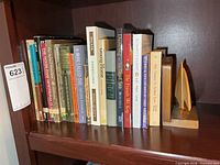 Row of approximately 18 books on shelf